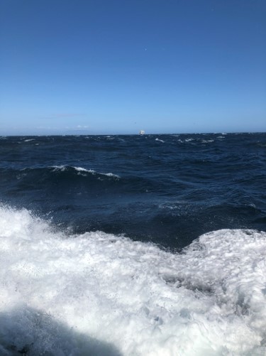 Boat ride home with oil rig in the distance